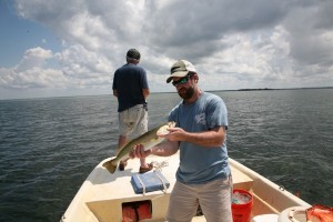 Mark Olis holding another of the daily catch